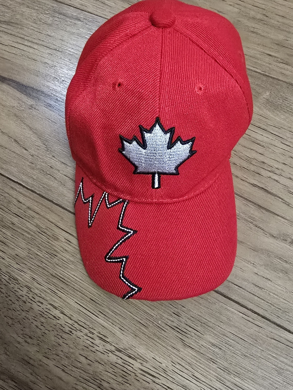 Needles Kids Red Cap with Silver Maple Leaf Emblem